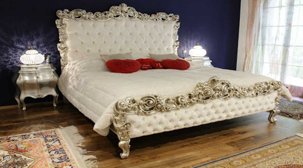 A luxurious white king-size bed for the men’s bedroom