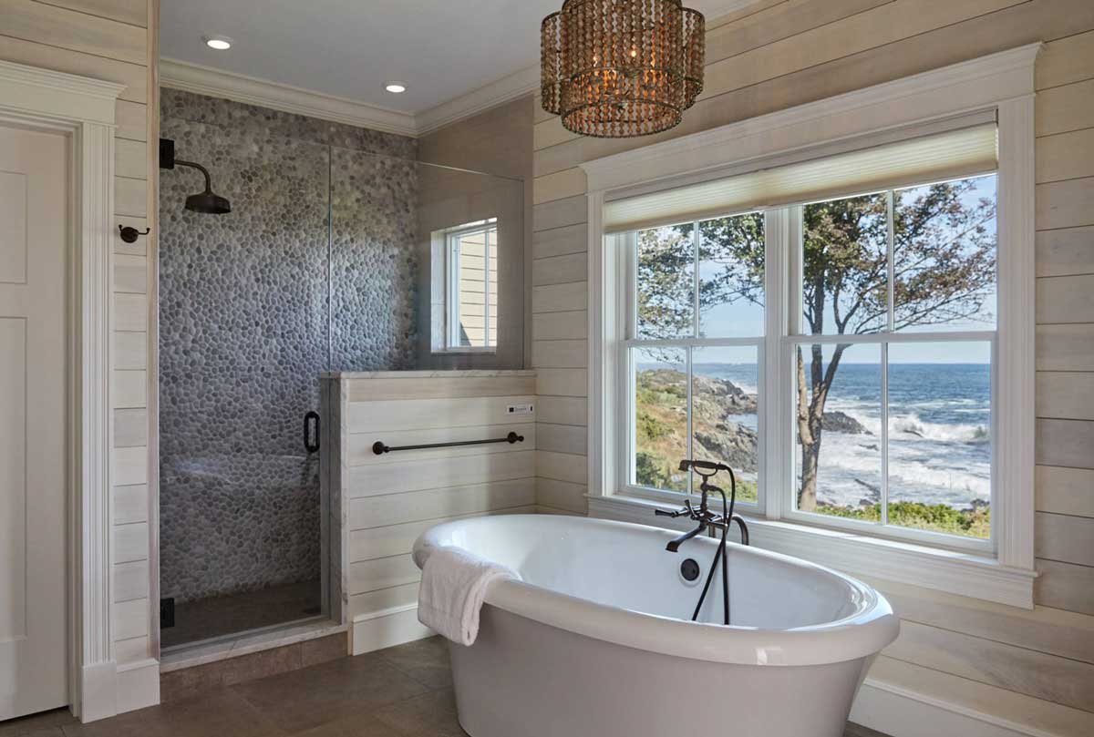 Have pebbles fitted on the wall and the bathtub as well to create beach vibes