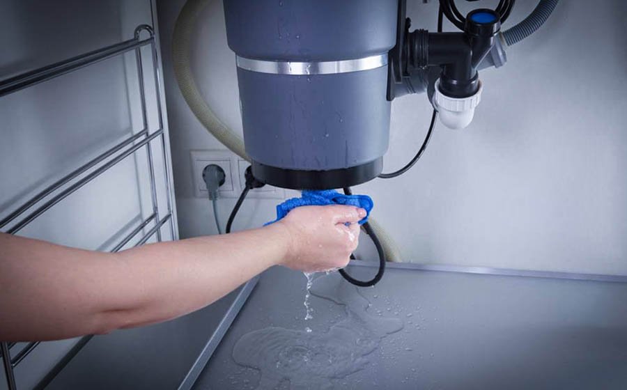 What are the common reasons for a garbage disposal not draining or